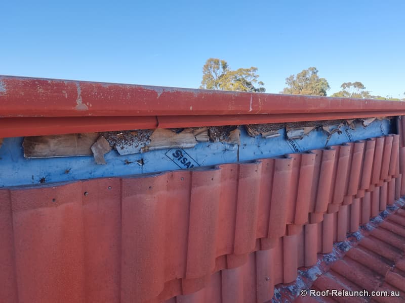 Showing vertical part of damaged tile roof