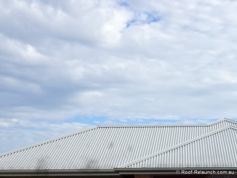 Closeup of a home's metal roof, damaged by fire