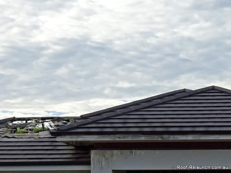 Closeup of a home's tile roof, damaged by fire