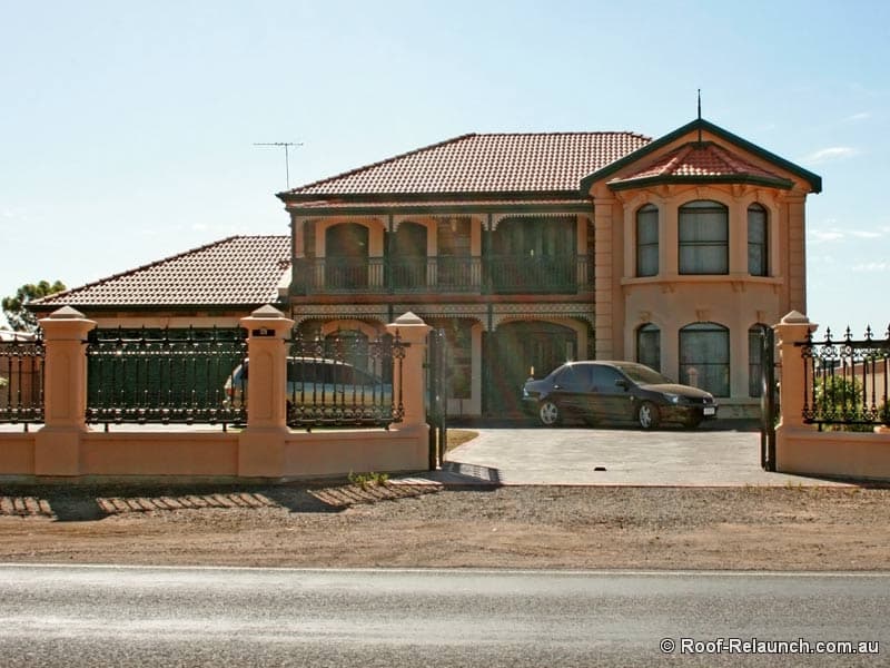 Photo of nice-looking home with newly replaced tile roof, showing two cars in the driveway, in South Australia
