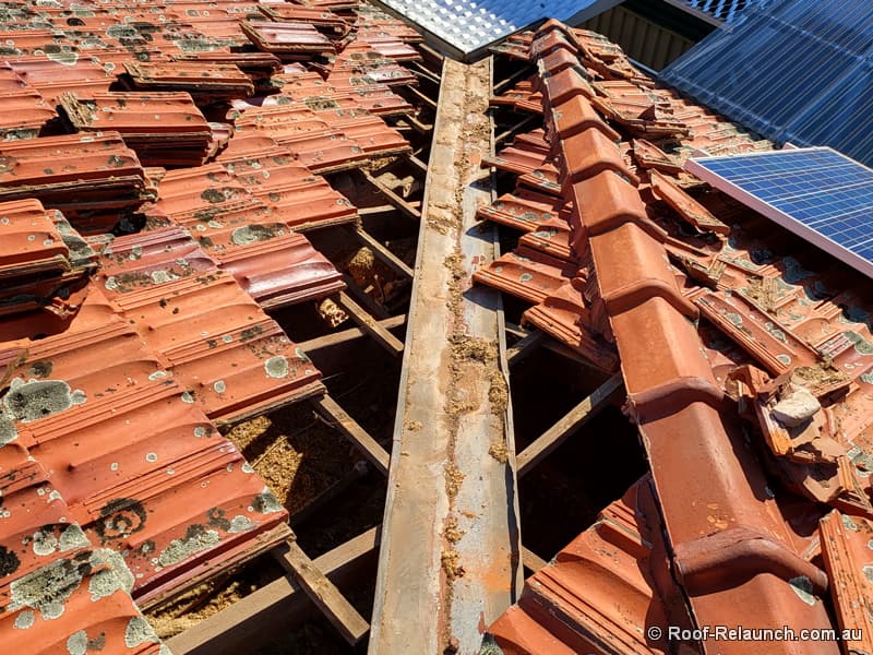 Before tile roof valley replacement, showing exposed and old valley